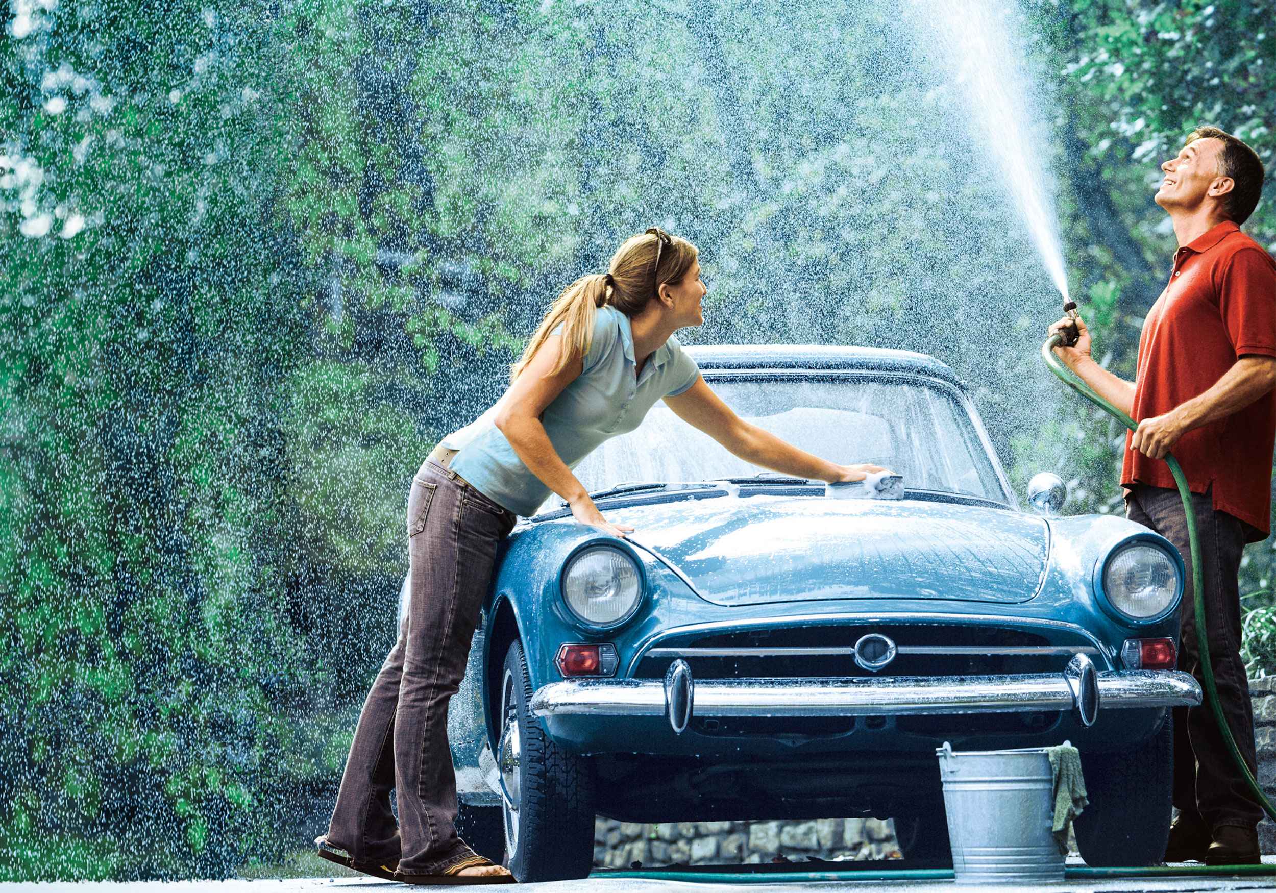 Ein Paar putzt ihren blaue Oldtimer